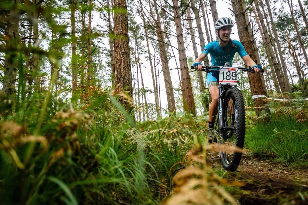 A man riding a Lapierre road bike up a hill