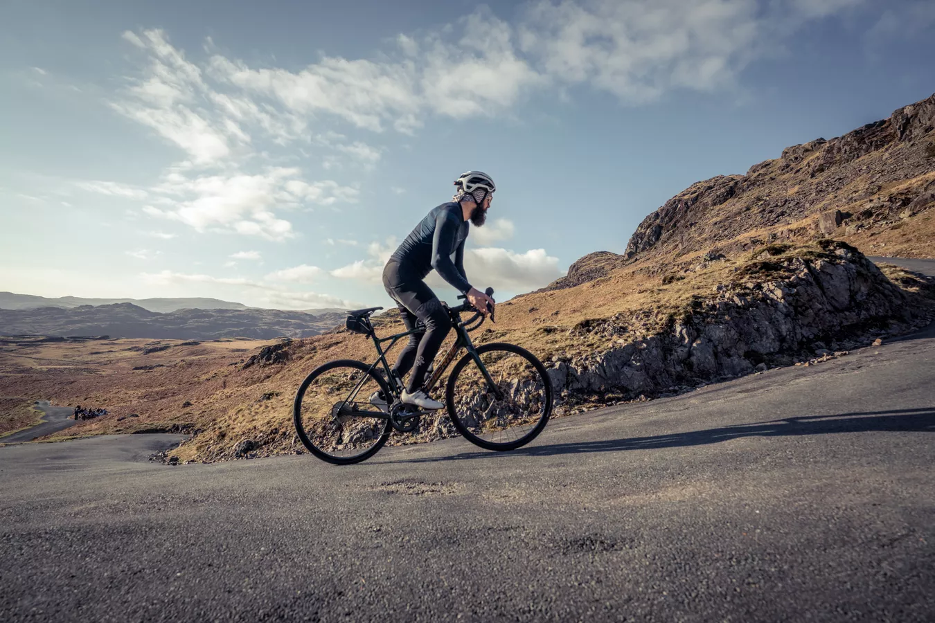 A man riding a Lapierre road bike up a hill