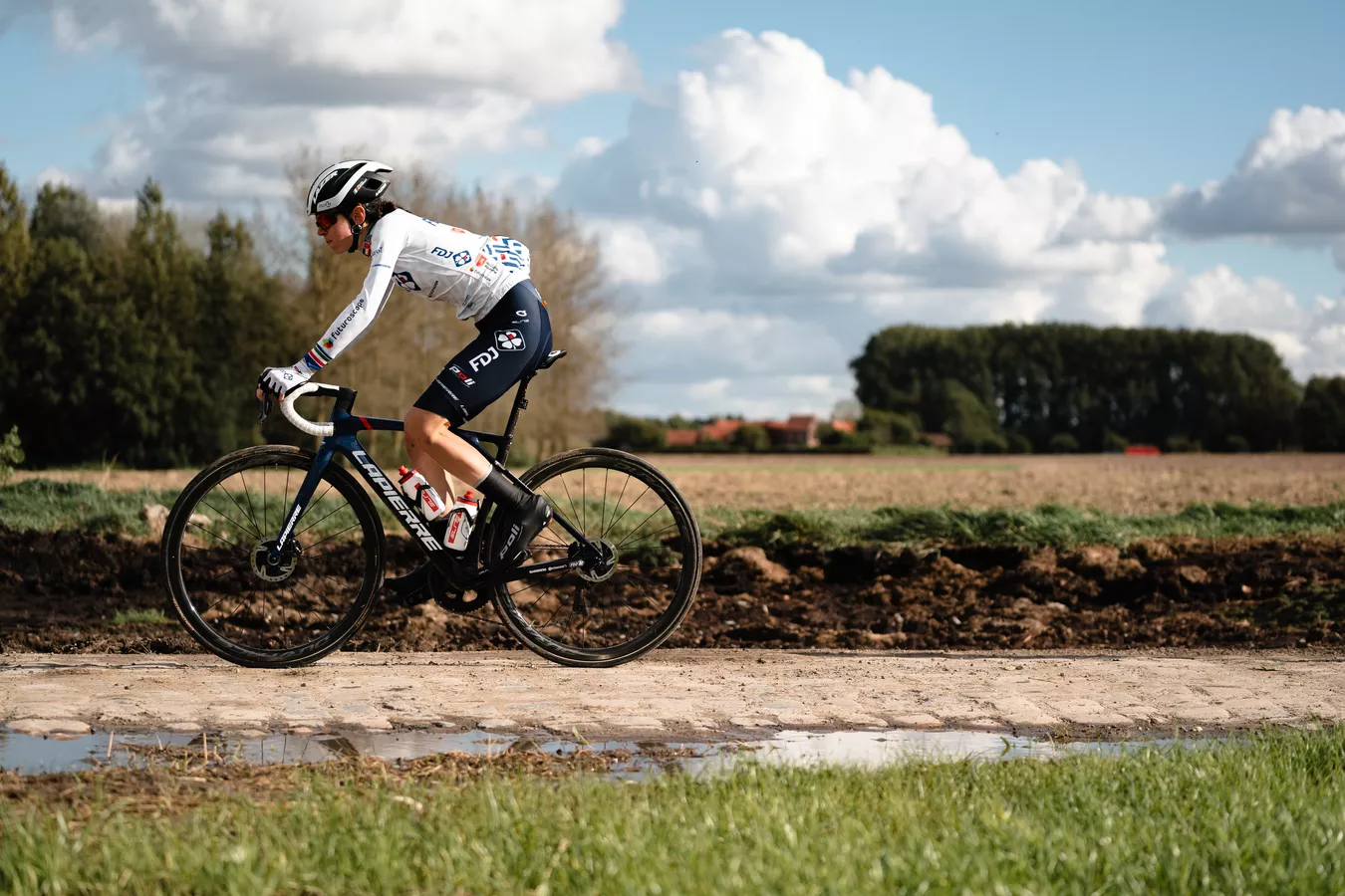 A man riding a Lapierre road bike up a hill