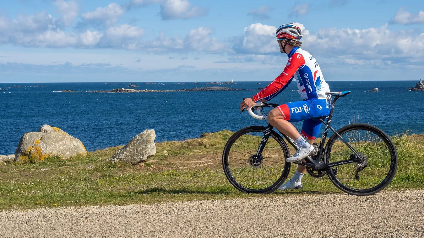 A man riding a Lapierre road bike up a hill